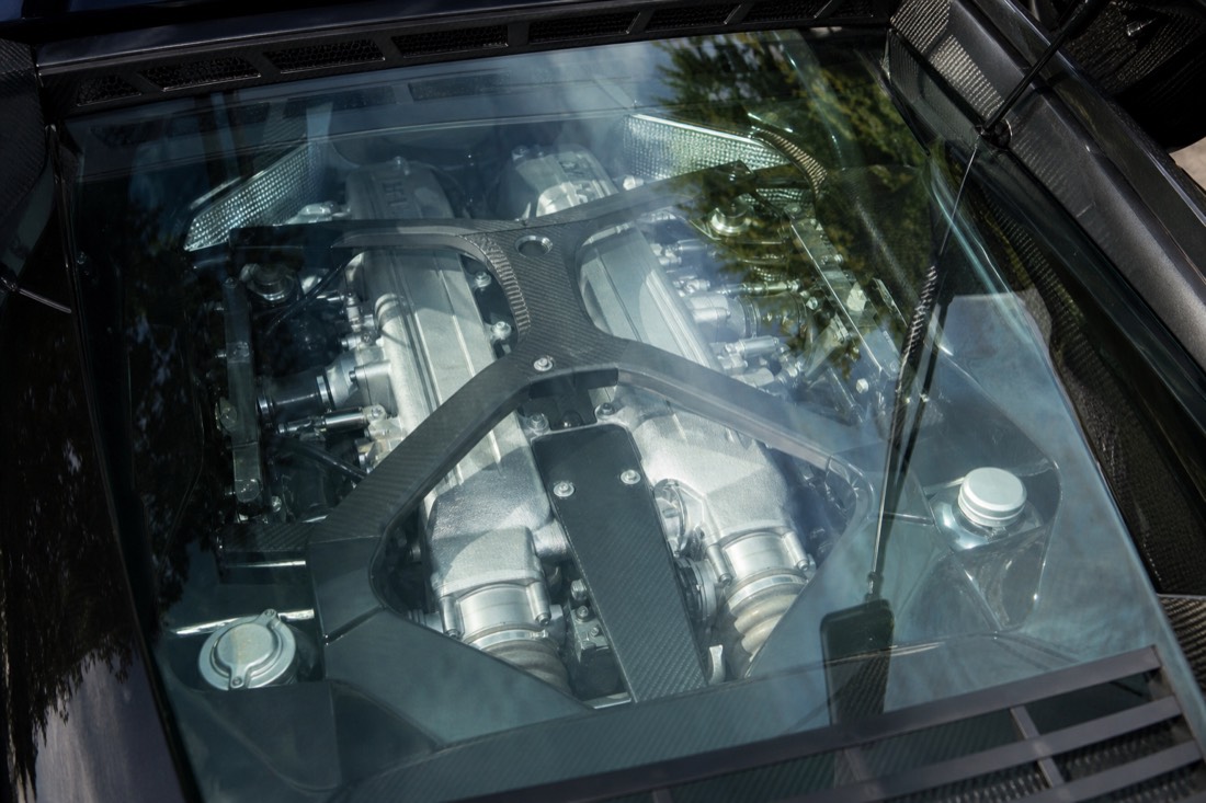 The exposed engine bay of a mid-engine exotic supercar